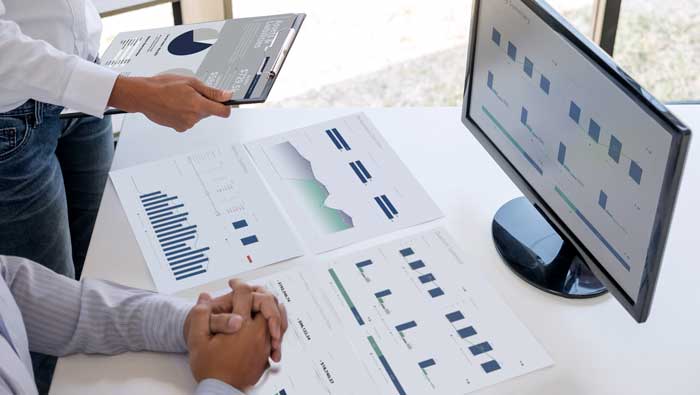 man and woman reviewing Reach Reporting reports