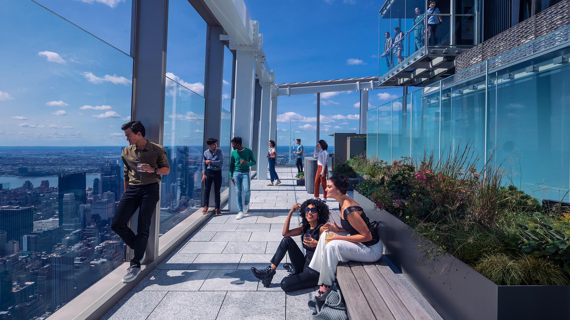 Guests taking in the view from a wrap-around outdoor rooftop terrace in NYC.